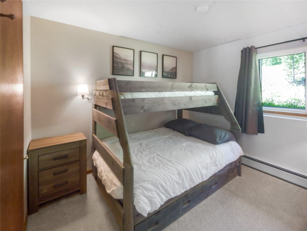 9876 Ryan Gulch Road, Unit 106 Silverthorne, CO 80498 - Photo 16 of 27 a bedroom with a bed and window