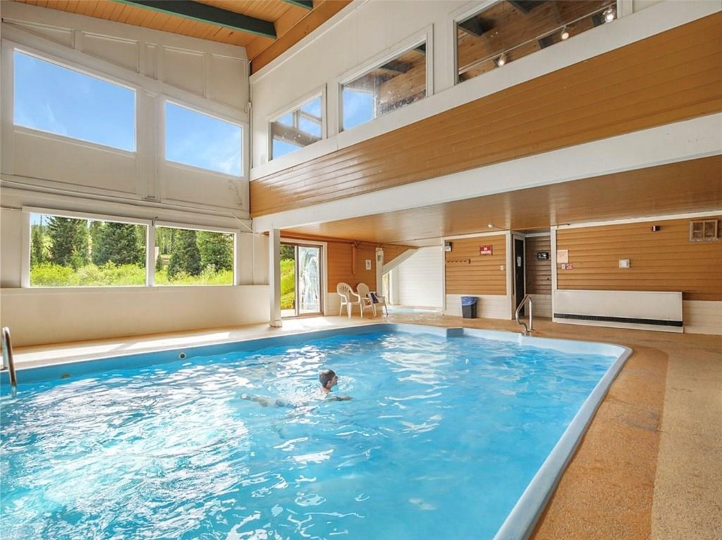 9876 Ryan Gulch Road, Unit 106 Silverthorne, CO 80498 - Photo 25 of 27 a view of an empty room with wooden floor and a window