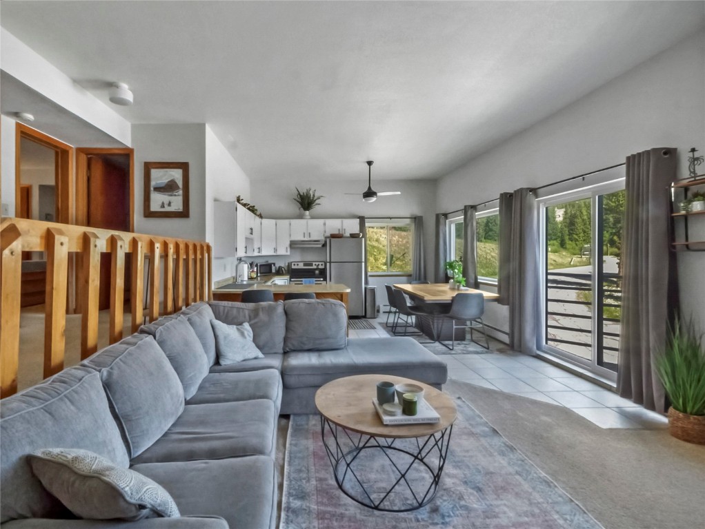 9876 Ryan Gulch Road, Unit 106 Silverthorne, CO 80498 - Photo 4 of 27 a living room with furniture and a large window
