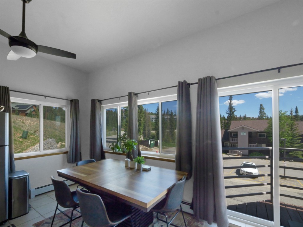 9876 Ryan Gulch Road, Unit 106 Silverthorne, CO 80498 - Photo 7 of 27 a view of a dining room with furniture window and outside view