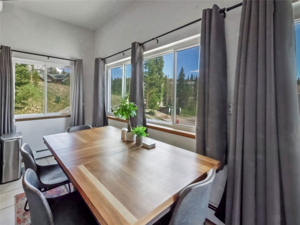 9876 Ryan Gulch Road, Unit 106 Silverthorne, CO 80498 - Photo 8 of 27 a view of a dining room with furniture window and wooden floor