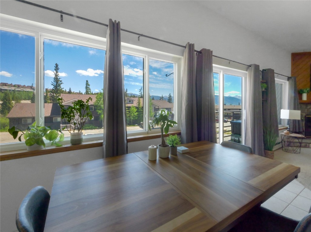 9876 Ryan Gulch Road, Unit 106 Silverthorne, CO 80498 - Photo 9 of 27 a view of room with wooden floor and windows