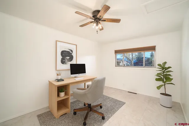 a workspace with furniture and a potted plant