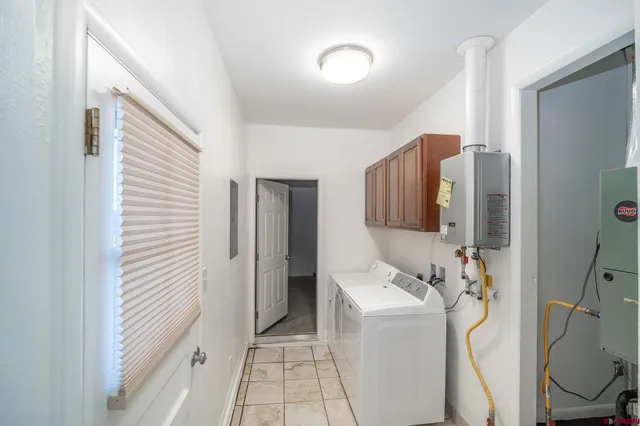 a bathroom with a sink and mirror with bathtub