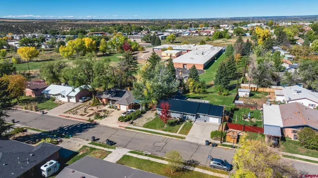 an aerial view of a house with a yard