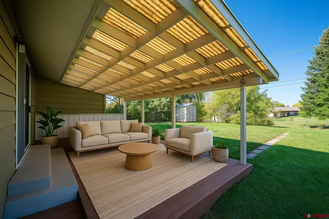 a view of a patio with couches chairs and a big yard