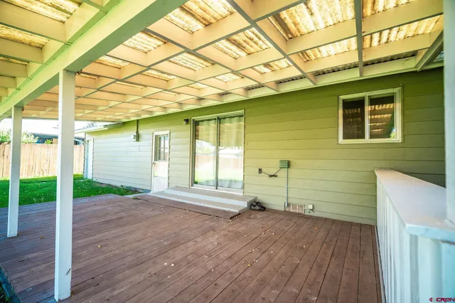 a view of a porch with wooden floor and fence