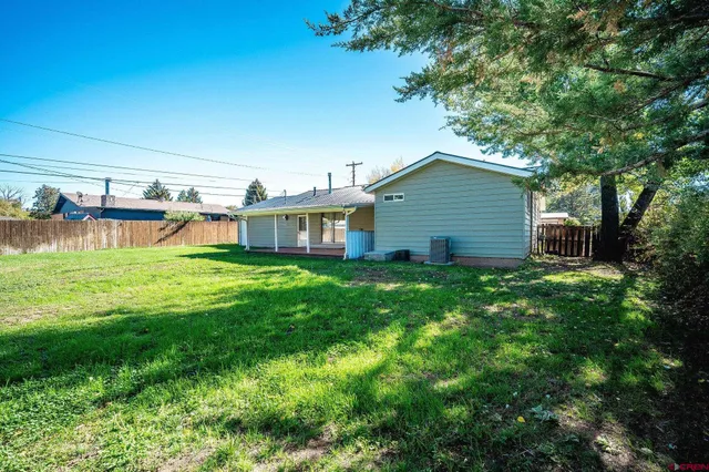 a view of a house with a yard porch and sitting area