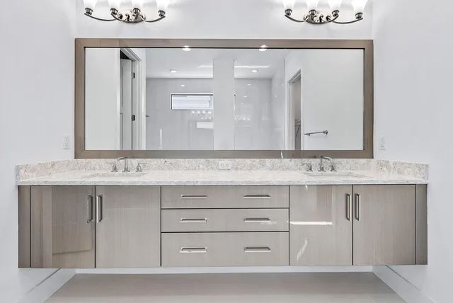 a bathroom with a sink vanity and mirror