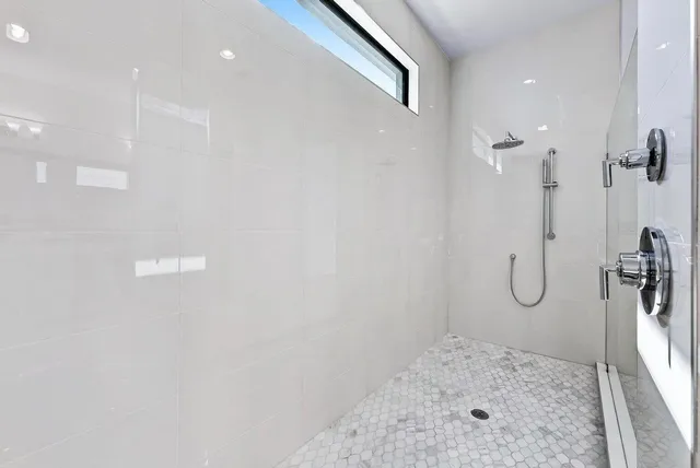a bathroom with a granite countertop shower and a sink