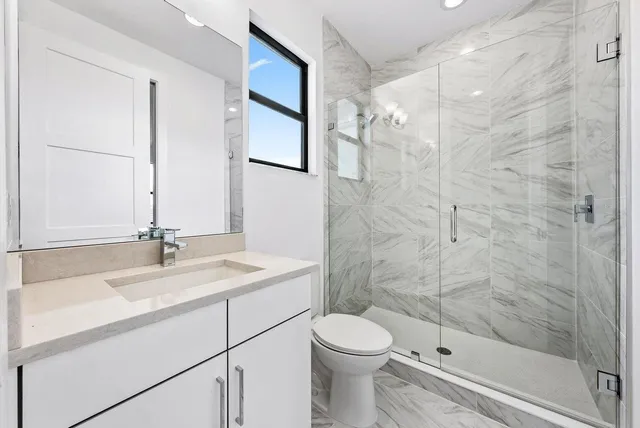 a bathroom with a sink toilet and shower