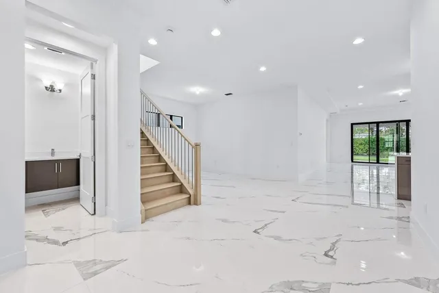 a view of entryway and hall with a open kitchen view