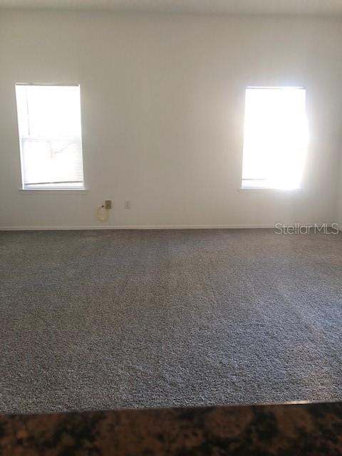 413 Summit Ridge Place, Unit 305 Longwood, FL 32779 - Photo 3 of 11 an empty room with wooden floor and a window