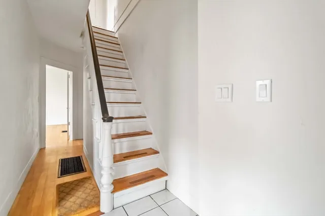 a view of a room with wooden floor and staircase