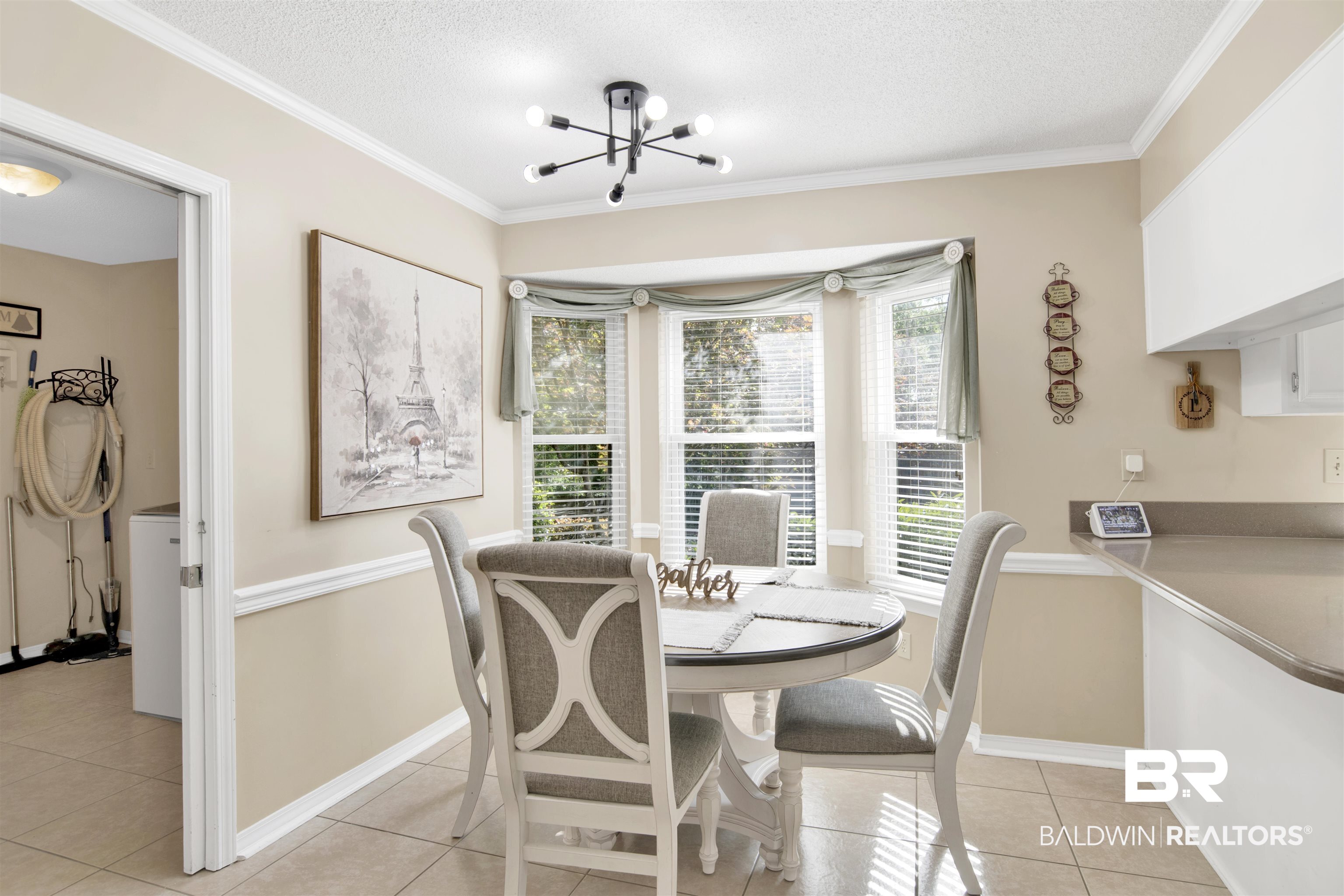7431 Summer Court Mobile, AL 36695 - Photo 16 of 37 Dining space with a textured ceiling, light tile patterned flooring, a chandelier, crown molding, and baseboards