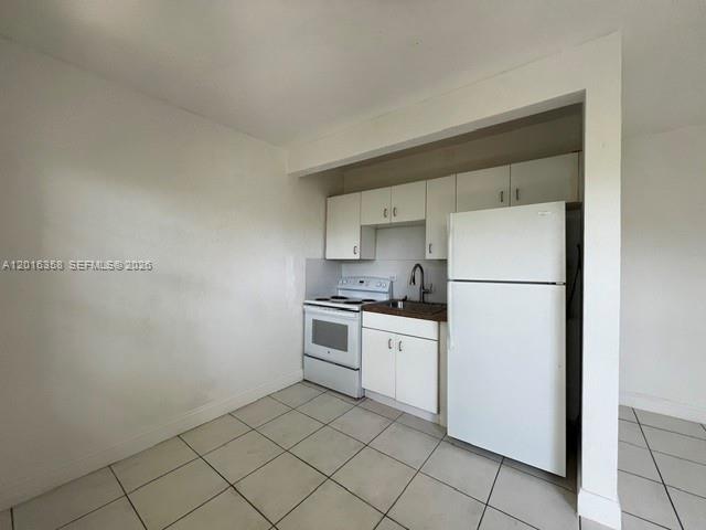 441 Southwest 10th Street, Unit 4 Miami, FL 33130 - Photo 2 of 18 a kitchen with cabinets and white stainless steel appliances