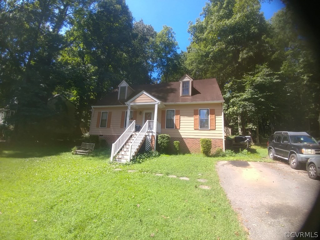 a view of a house with a yard and sitting area
