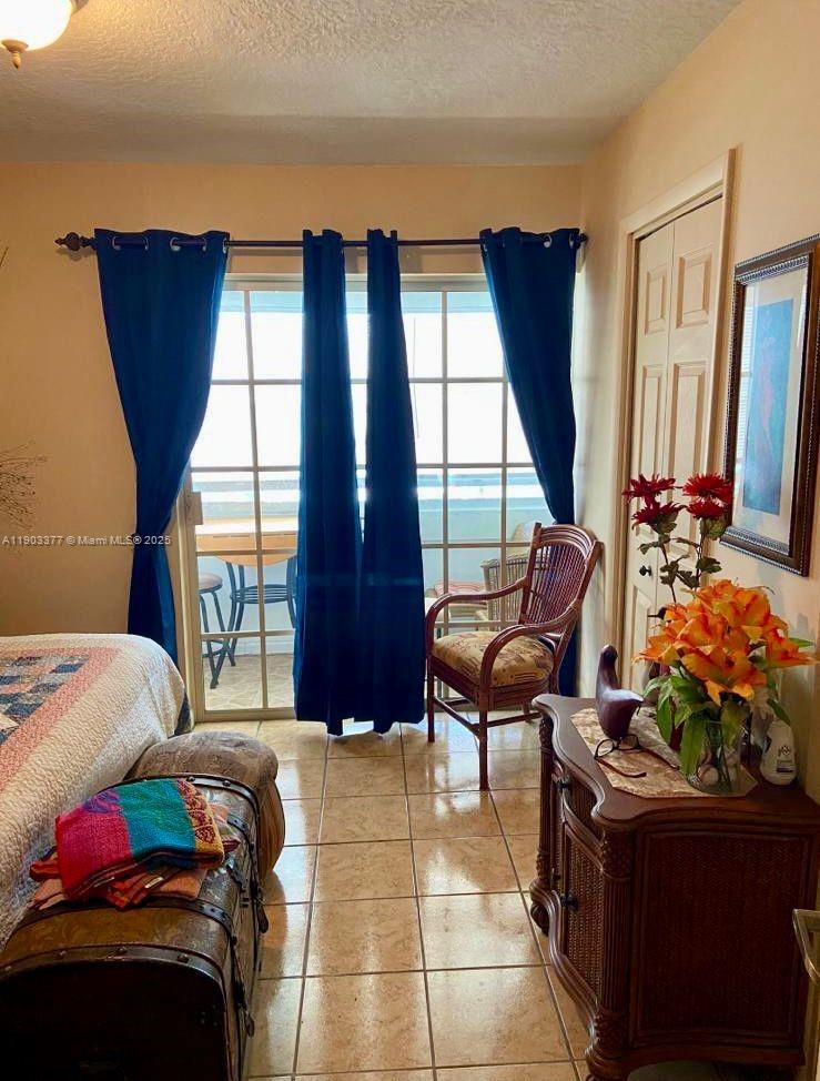 15610 Northeast 6th Avenue, Unit 32D Miami, FL 33162 - Photo 11 of 15 a bedroom with furniture and a window