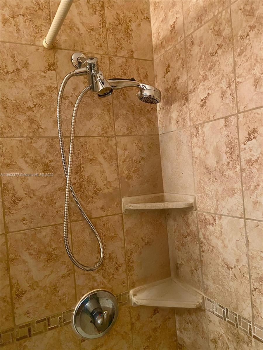 15610 Northeast 6th Avenue, Unit 32D Miami, FL 33162 - Photo 14 of 15 a bathroom with a shower