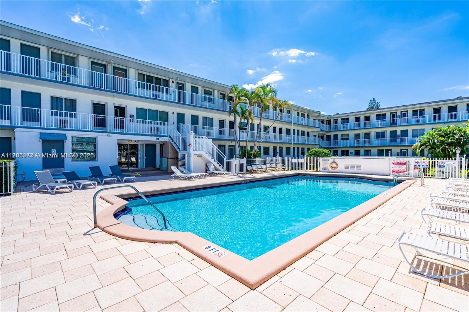 15610 Northeast 6th Avenue, Unit 32D Miami, FL 33162 - Photo 5 of 15 a view of swimming pool with outdoor seating