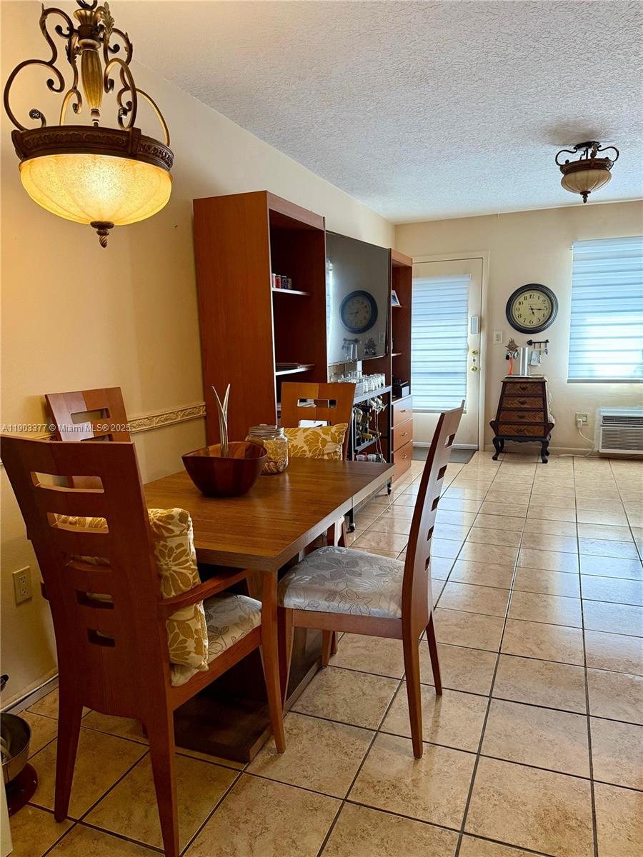 15610 Northeast 6th Avenue, Unit 32D Miami, FL 33162 - Photo 7 of 15 a view of a dining room with furniture