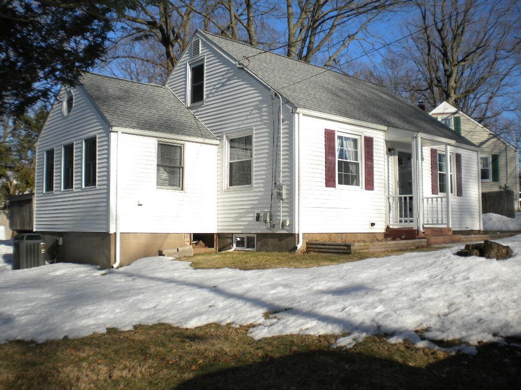 a view of a house with a yard and large tree