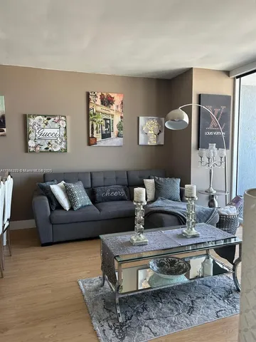 a dining room with furniture a chandelier and window
