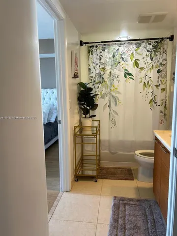 a living room with furniture and large windows