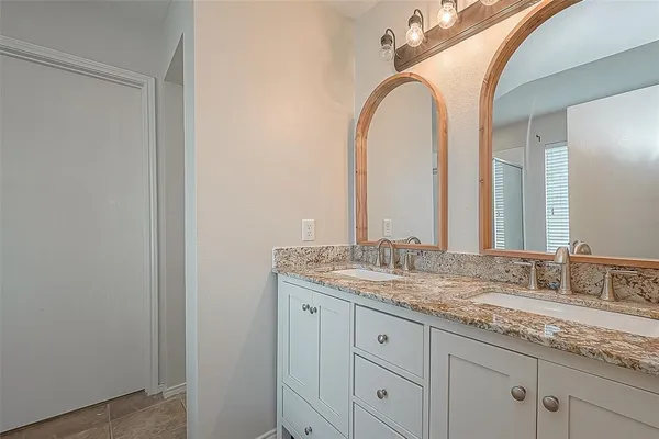 a bathroom with a granite countertop sink a mirror and a