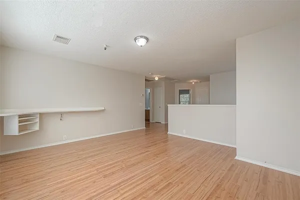 a view of a kitchen with wooden floor and a sink
