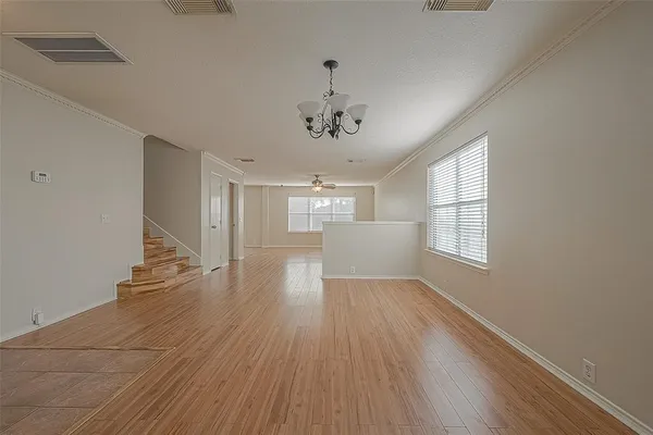 a view of a livingroom with wooden floor and a window
