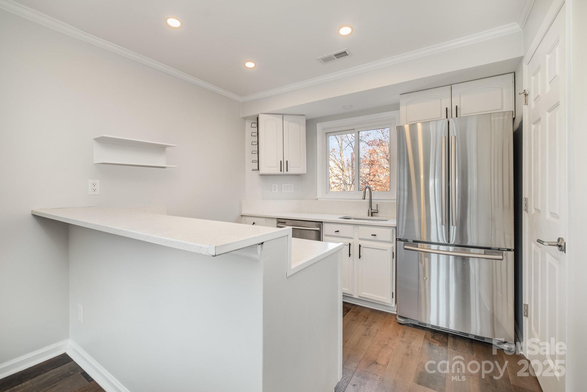 433 West 8th Street Charlotte, NC 28202 - Photo 11 of 25 a kitchen with appliances cabinets and a sink