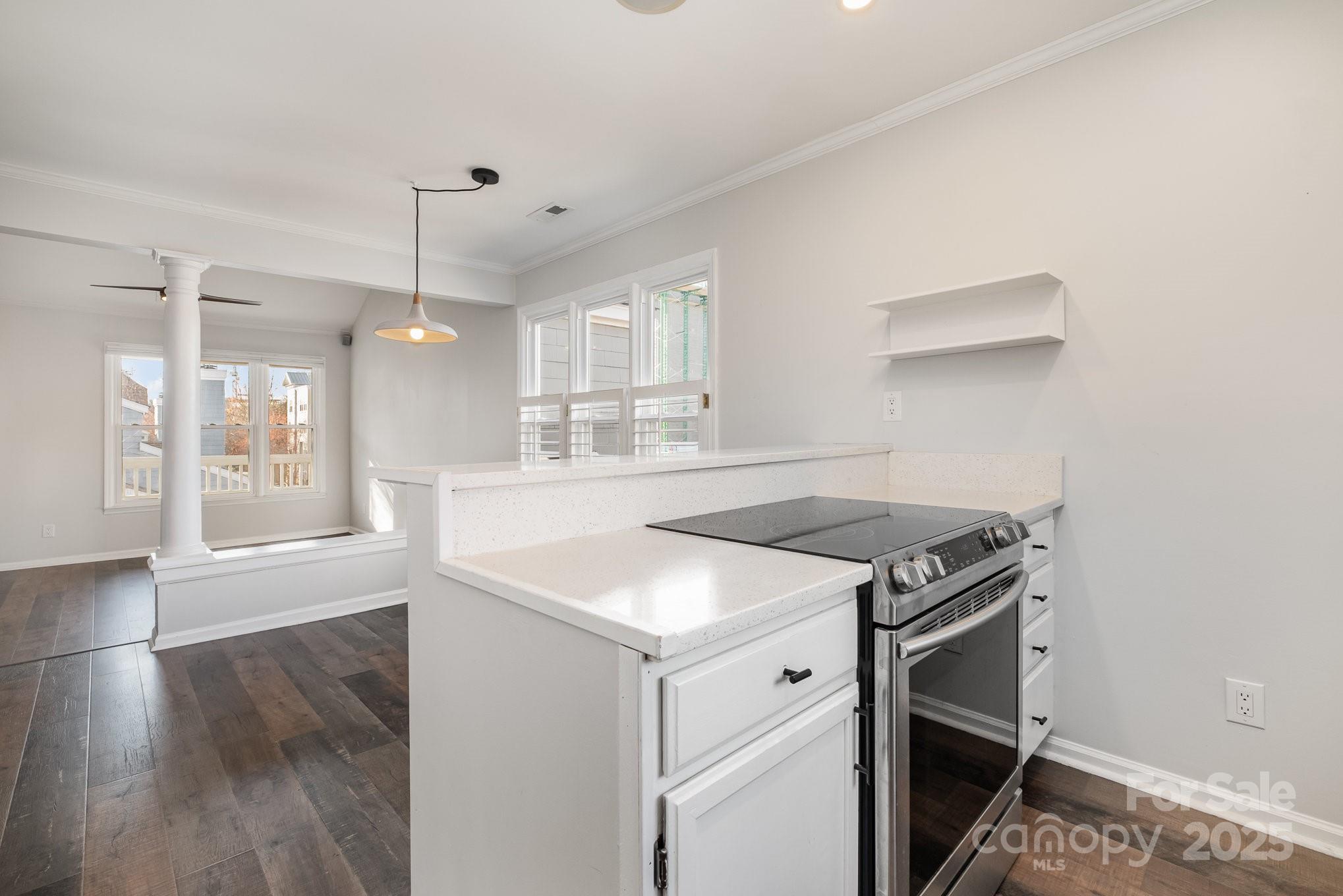 433 West 8th Street Charlotte, NC 28202 - Photo 12 of 25 a kitchen with a stove and a wooden floors