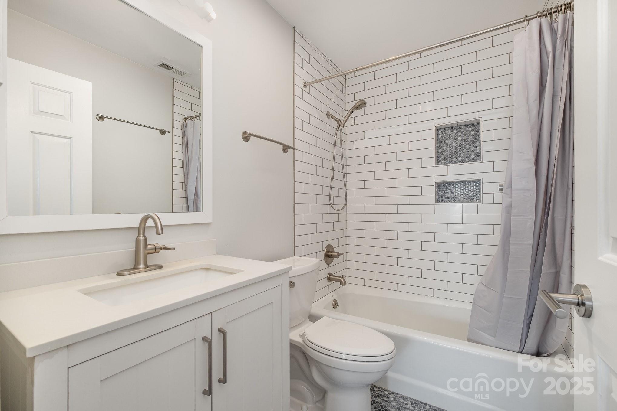 433 West 8th Street Charlotte, NC 28202 - Photo 14 of 25 a bathroom with a sink toilet and shower
