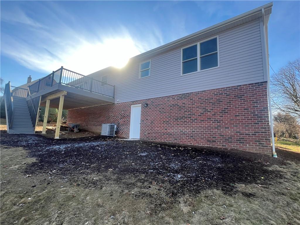141 Illinois Drive Lower Burrell, PA 15068 - Photo 3 of 23 24x12 trex deck with stairs, man door to garage