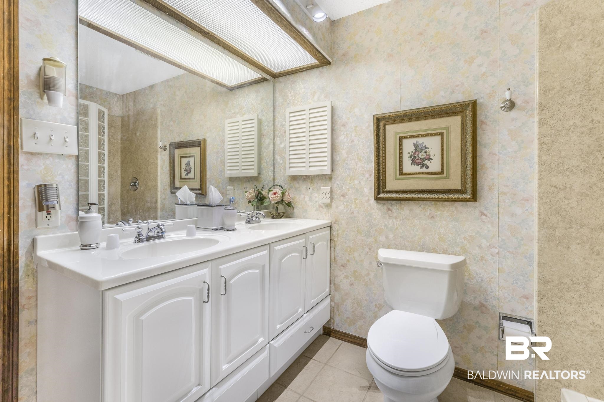10207 Plantation Drive Daphne, AL 36526 - Photo 22 of 48 Full bath with double vanity, light tile patterned floors, and wallpapered walls