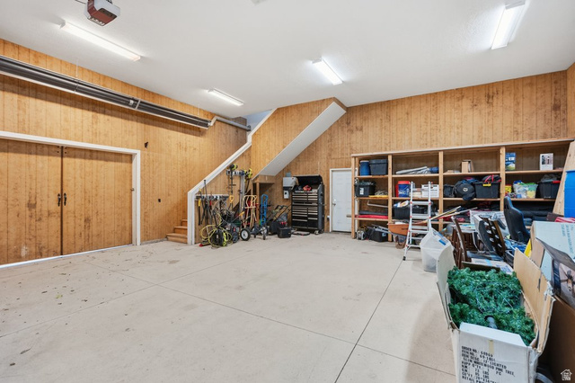 672 Perry Hollow Drive Mapleton, UT 84664 - Photo 86 of 106 Spacious garage with light wood-paneling walls and a concrete floor