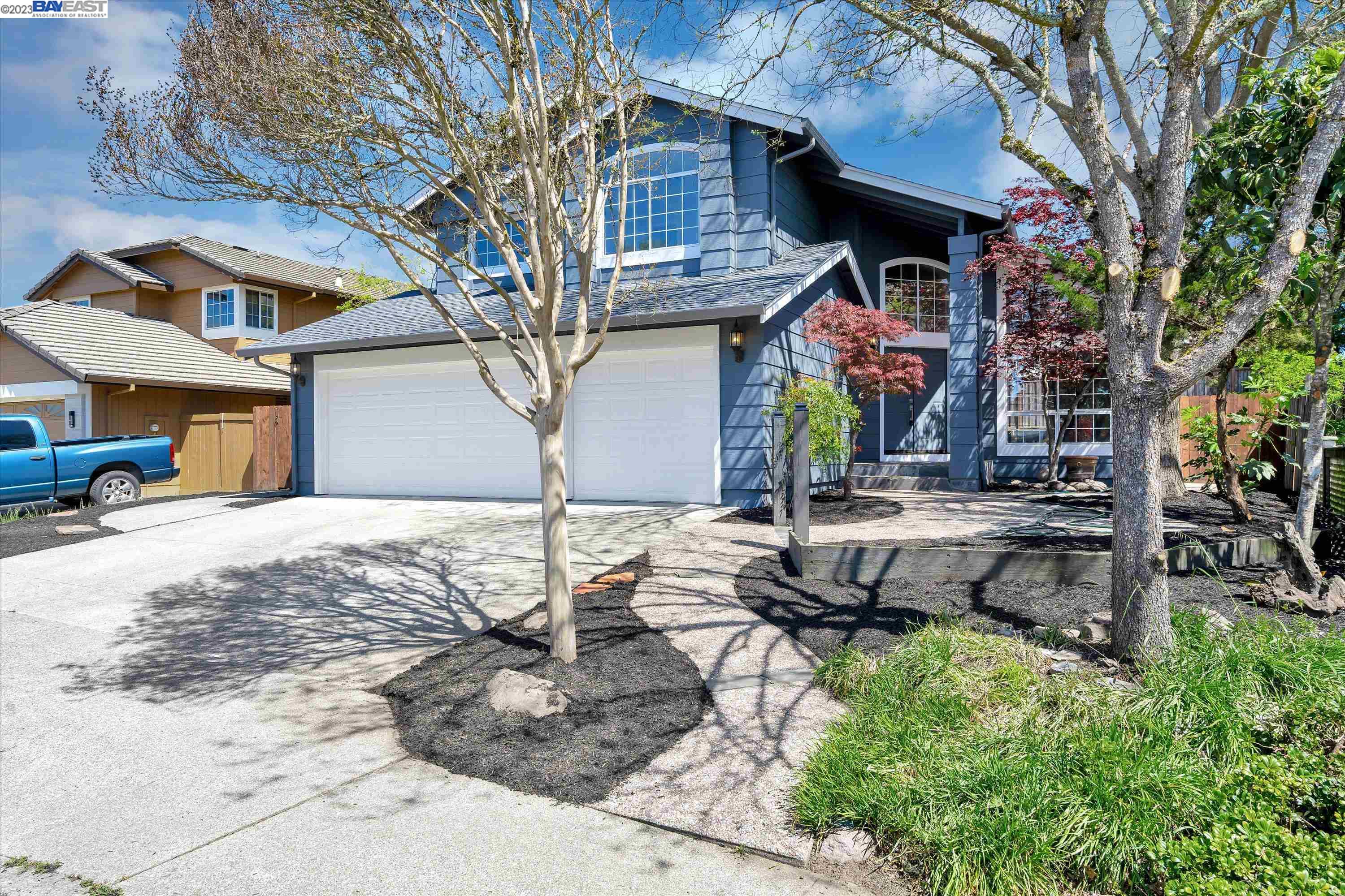 a view of a backyard with table and chairs under an umbrella