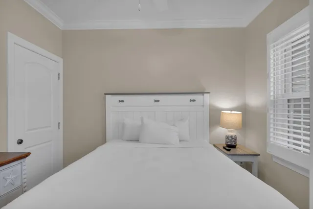 a bedroom with a bed and a lamp