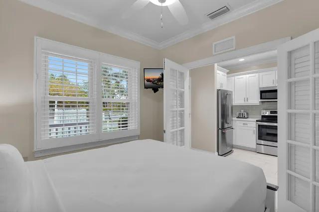 a bedroom with a bed a stove and a large window