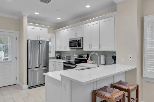 a kitchen with stainless steel appliances a refrigerator stove microwave and cabinets