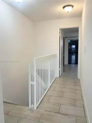 a white toilet sitting next to a bath tub and a shower