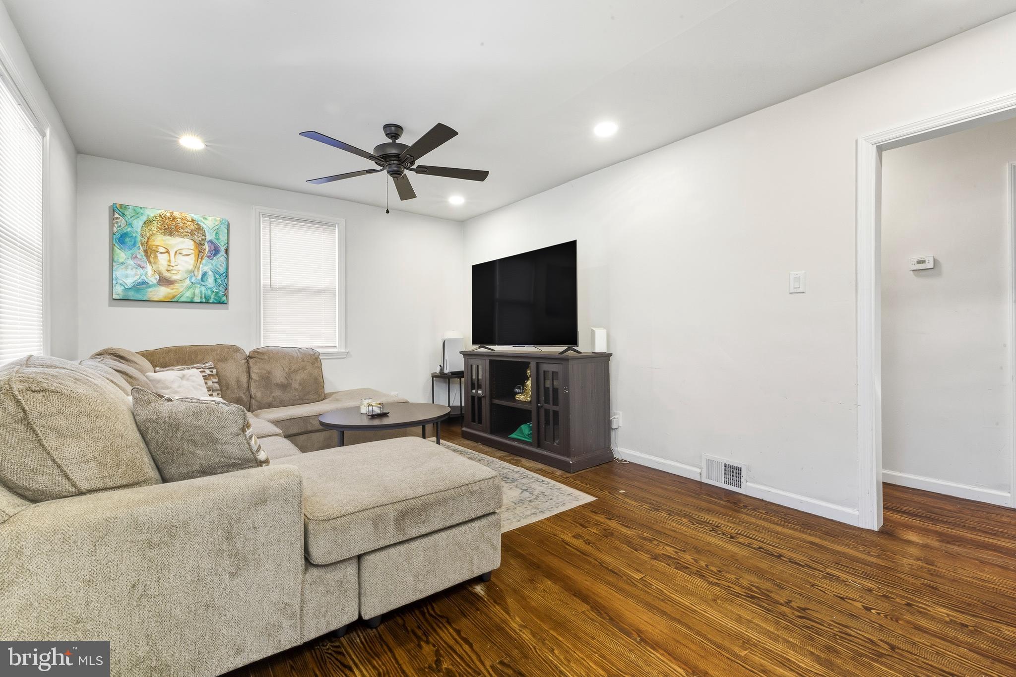 1287 Clements Bridge Road Woodbury, NJ 08096 - Photo 5 of 16 a living room with furniture and a flat screen tv