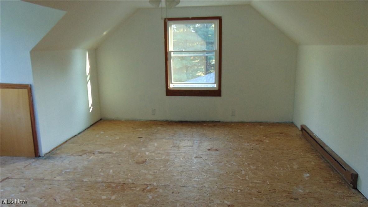 4970 Bryenton Road Litchfield, OH 44253 - Photo 25 of 33 Bonus room featuring a baseboard heating unit and lofted ceiling