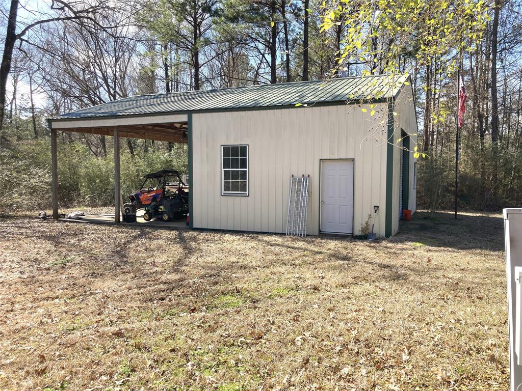 9515 Caddo Lake Road Mooringsport, LA 71060 - Photo 11 of 12 a view of a house with a yard covered in snow