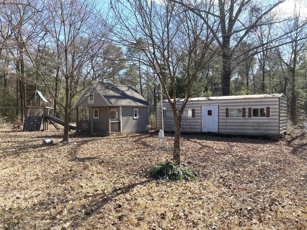 9515 Caddo Lake Road Mooringsport, LA 71060 - Photo 7 of 12 a front view of a house with a yard