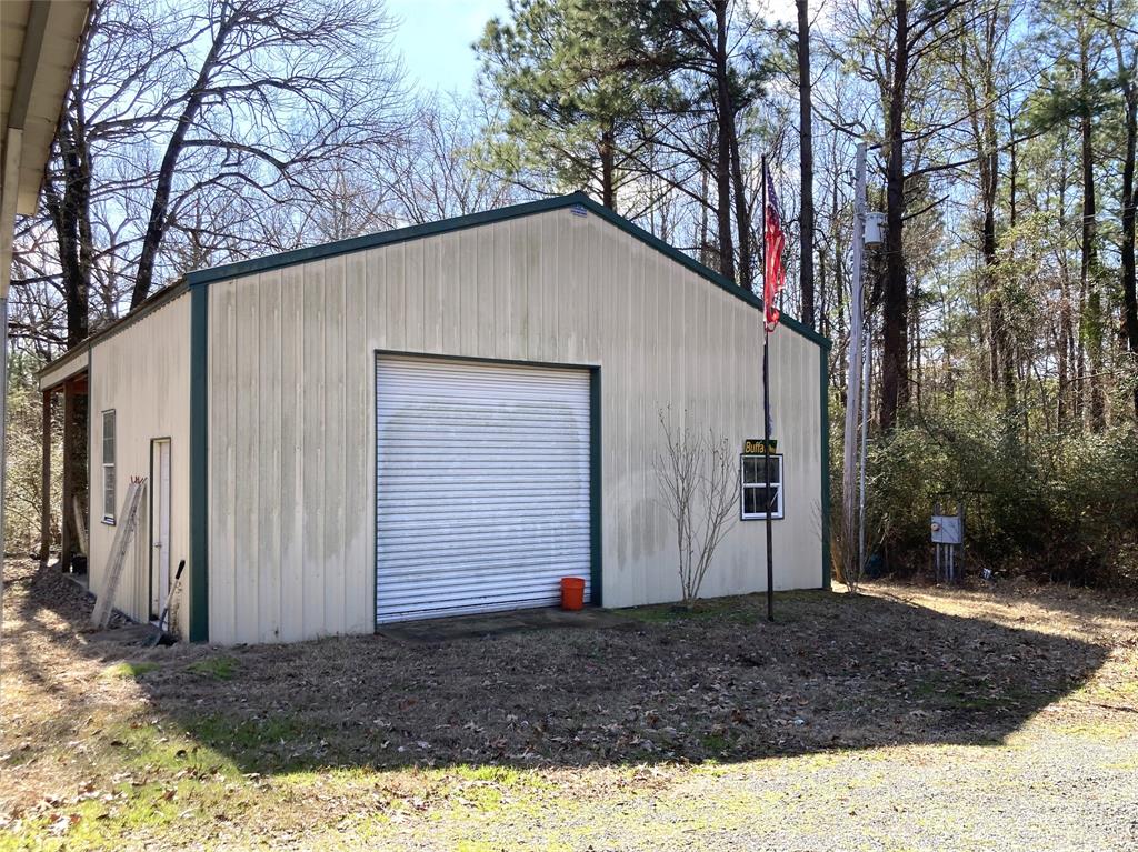 9515 Caddo Lake Road Mooringsport, LA 71060 - Photo 10 of 12 a view of a house with a yard
