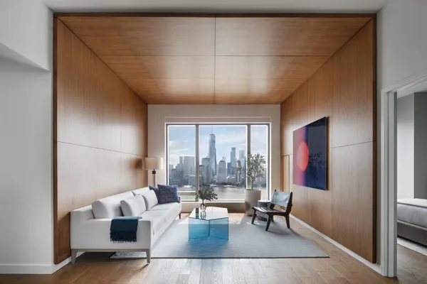 a living room with couches and a coffee table with garden view