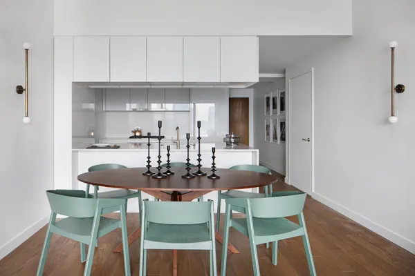 a dining room with furniture and wooden floor