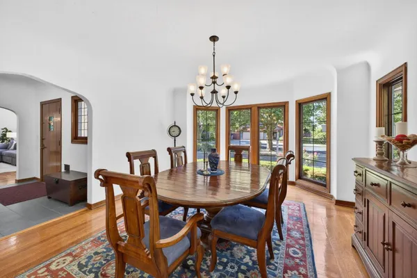 a view of a dining room with furniture wooden floor and chandelier